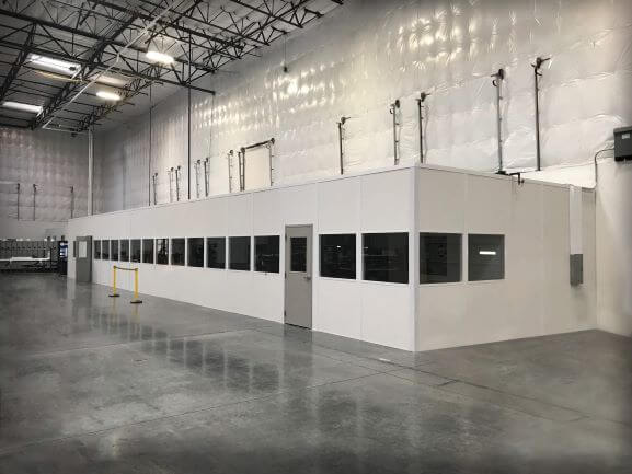 Prefabricated modular office with windows in industrial warehouse