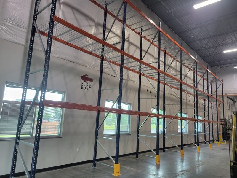 Pallet racking with wire decking and column protectors installed along warehouse wall in Hebron KY