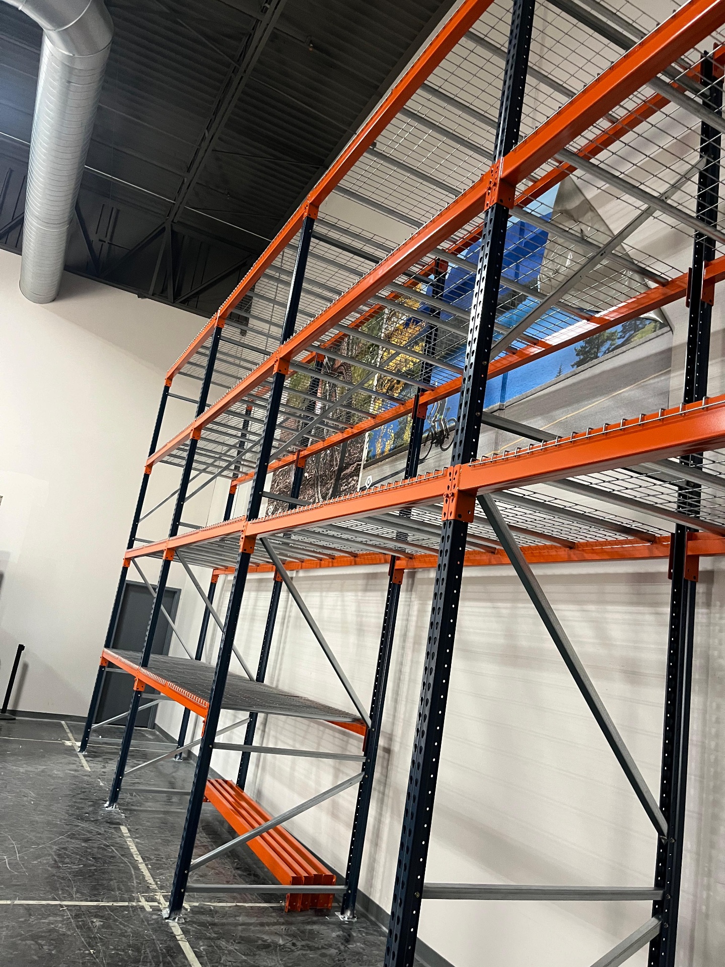 Tall pallet racking with wire decking and orange beams installed in North Richland Hills TX warehouse