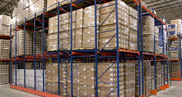 High-density pushback rack system with pallets stored deep in warehouse